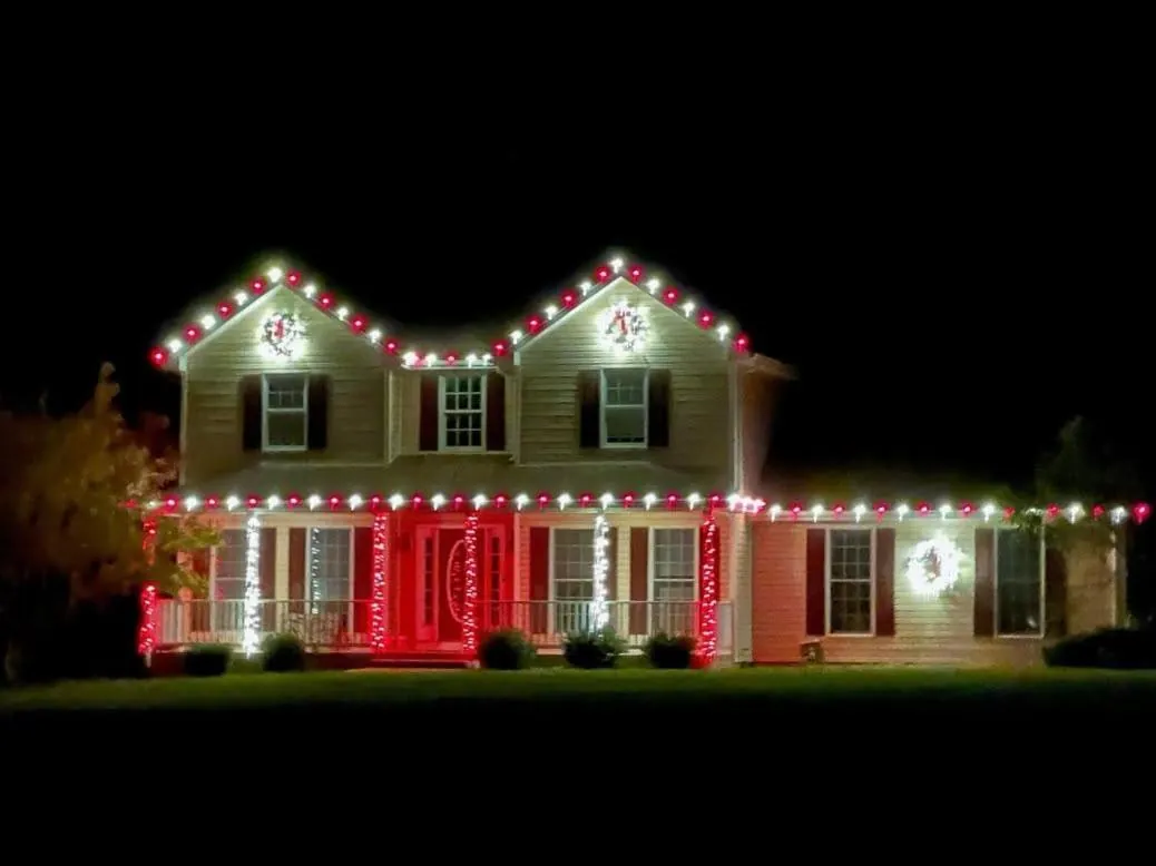 Swoope, VA home outlined in red and white lights with lit wreaths